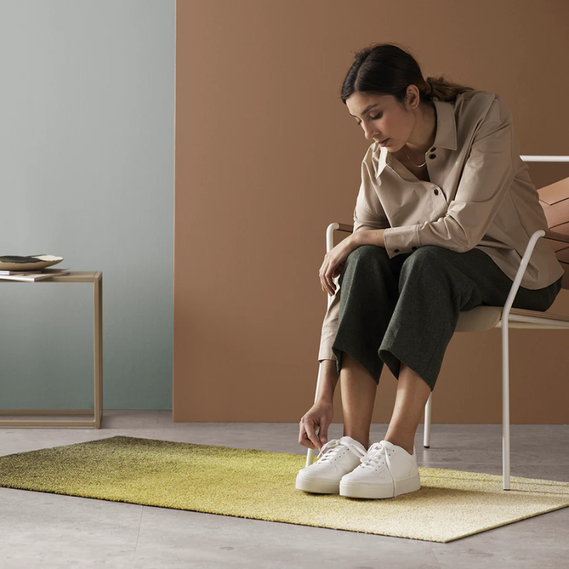 The Dis Doormat from Heymat in moss in a living room.