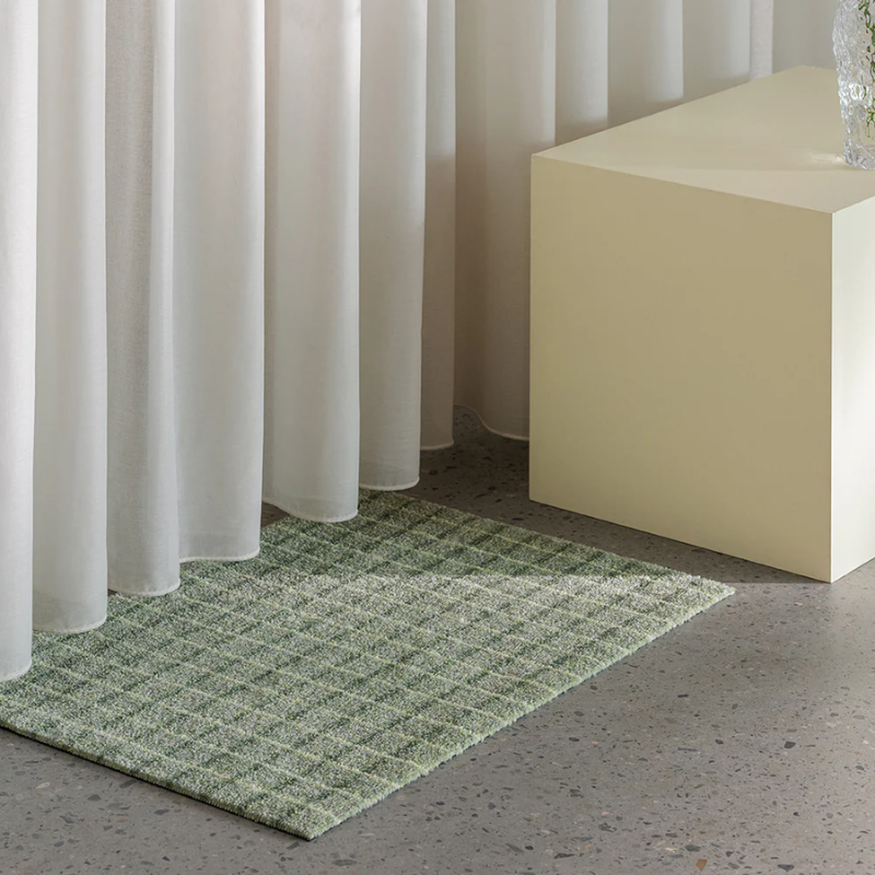 The Grid Doormat from Heymat in matcha lemon in a home.