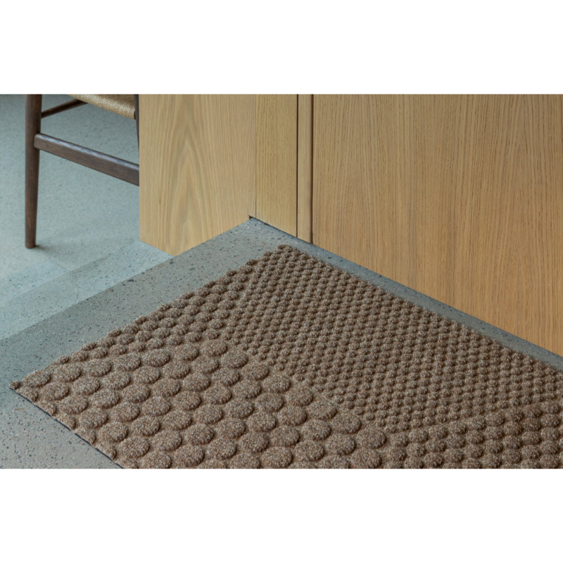 The Hex Doormat by Heymat in a lounge.
