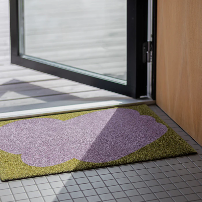 The Heymat x Sight Doormat from Heymat in unseen lilac in an entryway.