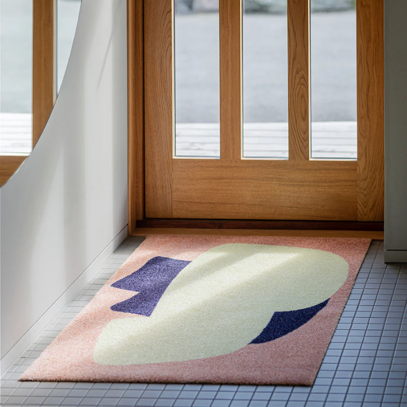 The Heymat x Sight Doormat from Heymat in unseen peach in a doorway.