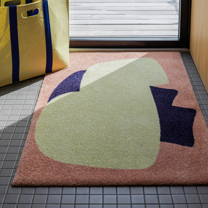 The Heymat x Sight Doormat from Heymat in unseen peach in an entryway.