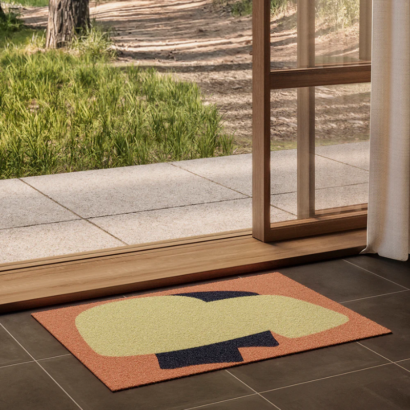 The Heymat x Sight Doormat from Heymat in unseen peach in a home.