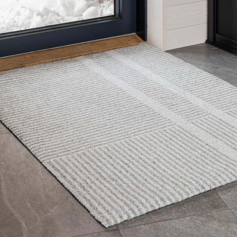 medium Løype doormat by Haymat in Breezy Beige in doorway.