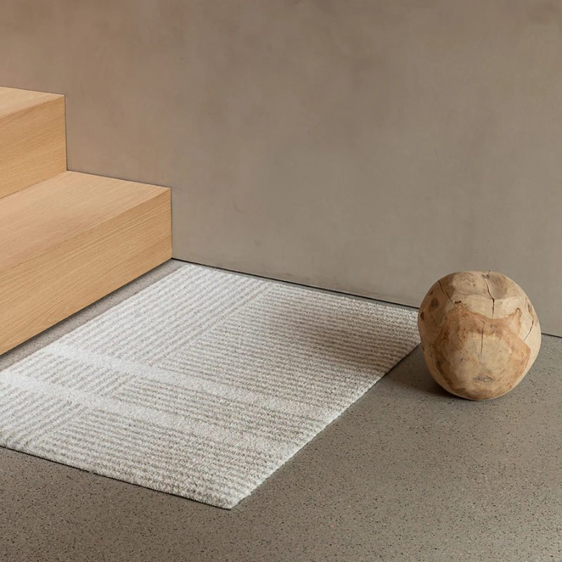 Small Løype doormat by Haymat in Breezy Beige at the bottom of stairs.