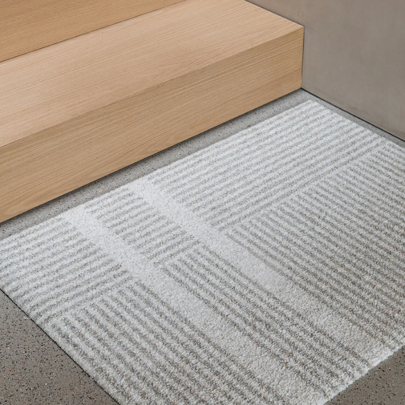 Small Løype doormat by Haymat in Breezy Beige in entryway.