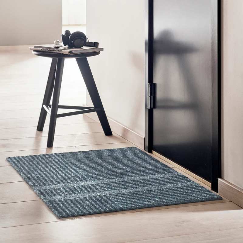 Small dark blue indoor doormat by Haymat in Stormy Blue in entry.