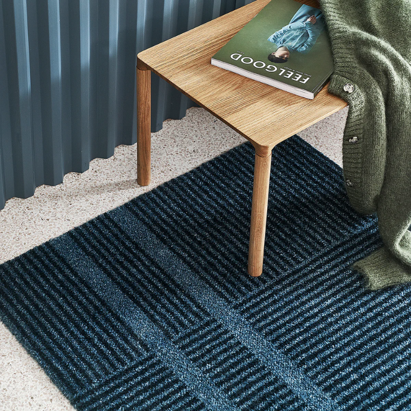 Medium Løype doormat by Haymat in Stormy Blue in living room.