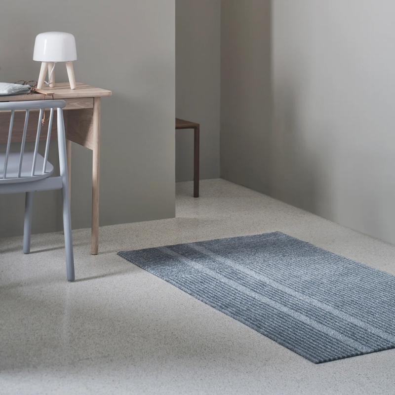 Small Løype doormat by Haymat in cloudy grey in bedroom.