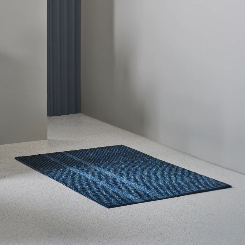 Medium Løype doormat by Haymat in Stormy Blue in living room.