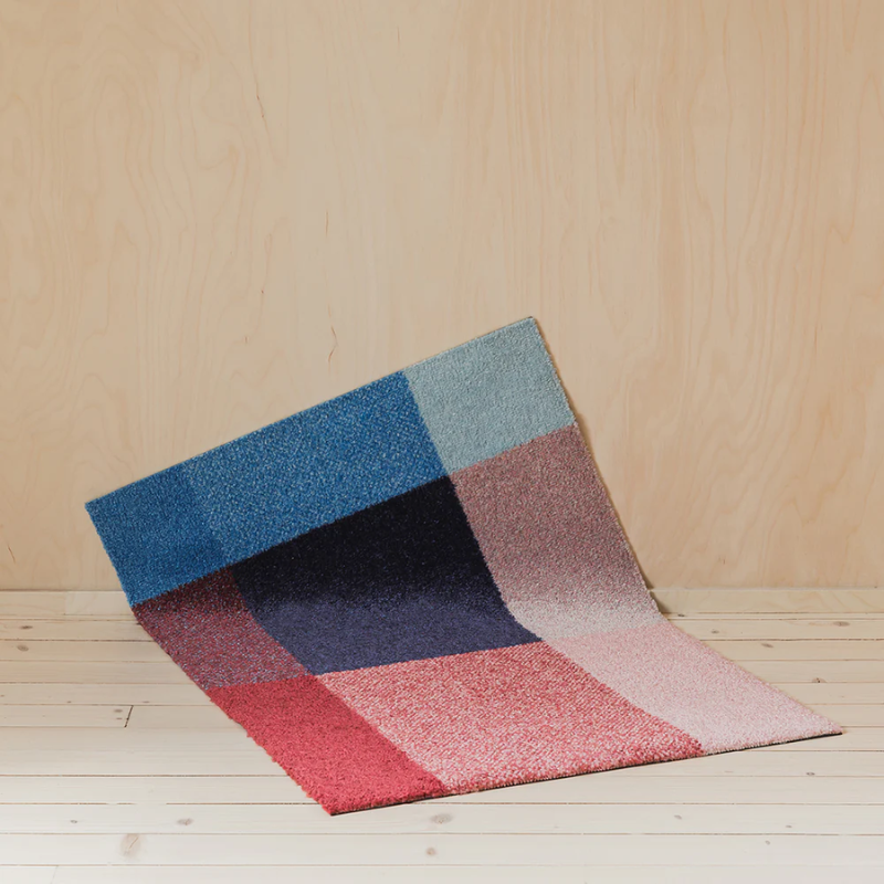 The Mix Doormat from Heymat in berry in a lounge.