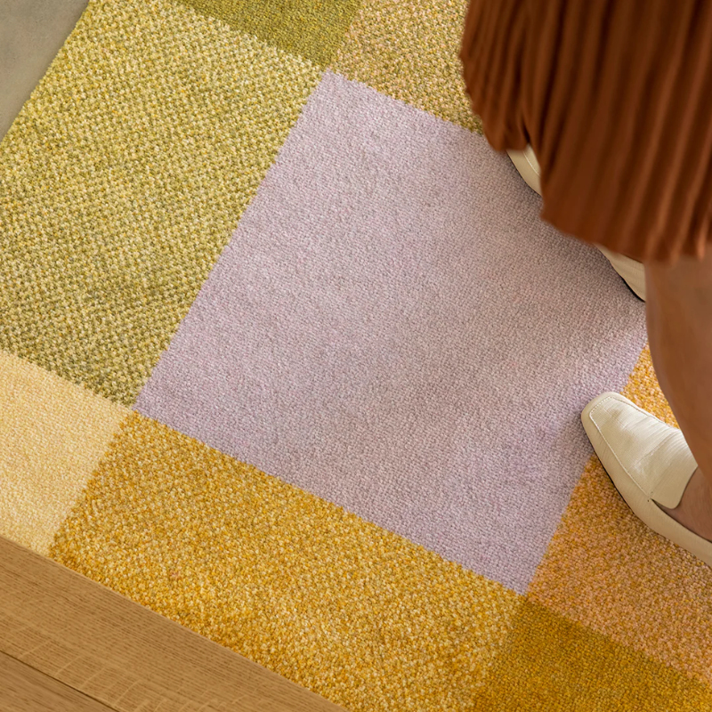 The Mix Teklan Entry Mat from Heymat in a living room.