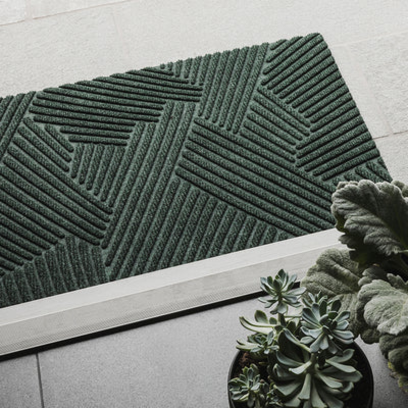 The Strå Doormat from Heymat in an entryway.