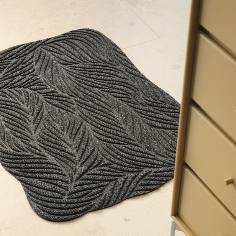 The Twine Doormat from Heymat in grey in a dressing room.