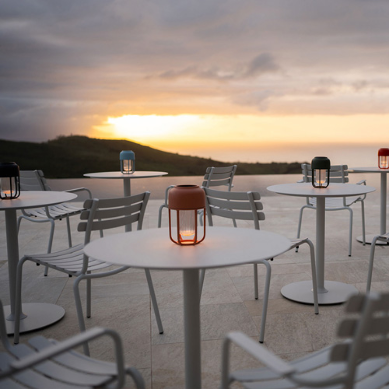 The Light No. 1 Portable Lamp from Houe outdoors on a rooftop, showing multiple color options. all-groups