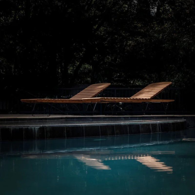 The Molo Sunbed by Houe with contrast at the poolside.