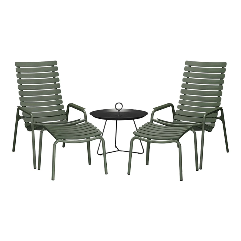The ReClips Outdoor Footrest by Houe with chairs and a round table setting.