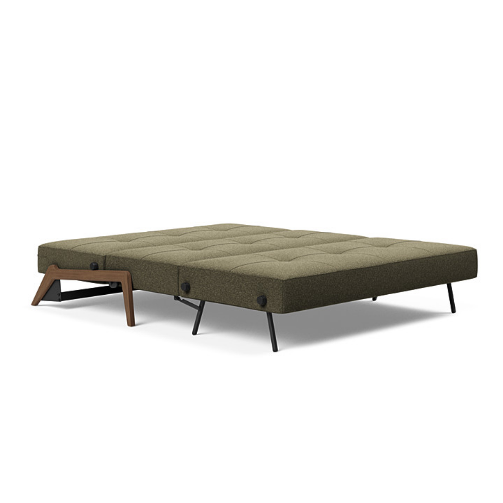The Cubed Queen Size Sleeper Sofa with Wood Legs from Innovation Living with dark lacquered oak legs and boucle forest green 535 upholstery setup as a bed.