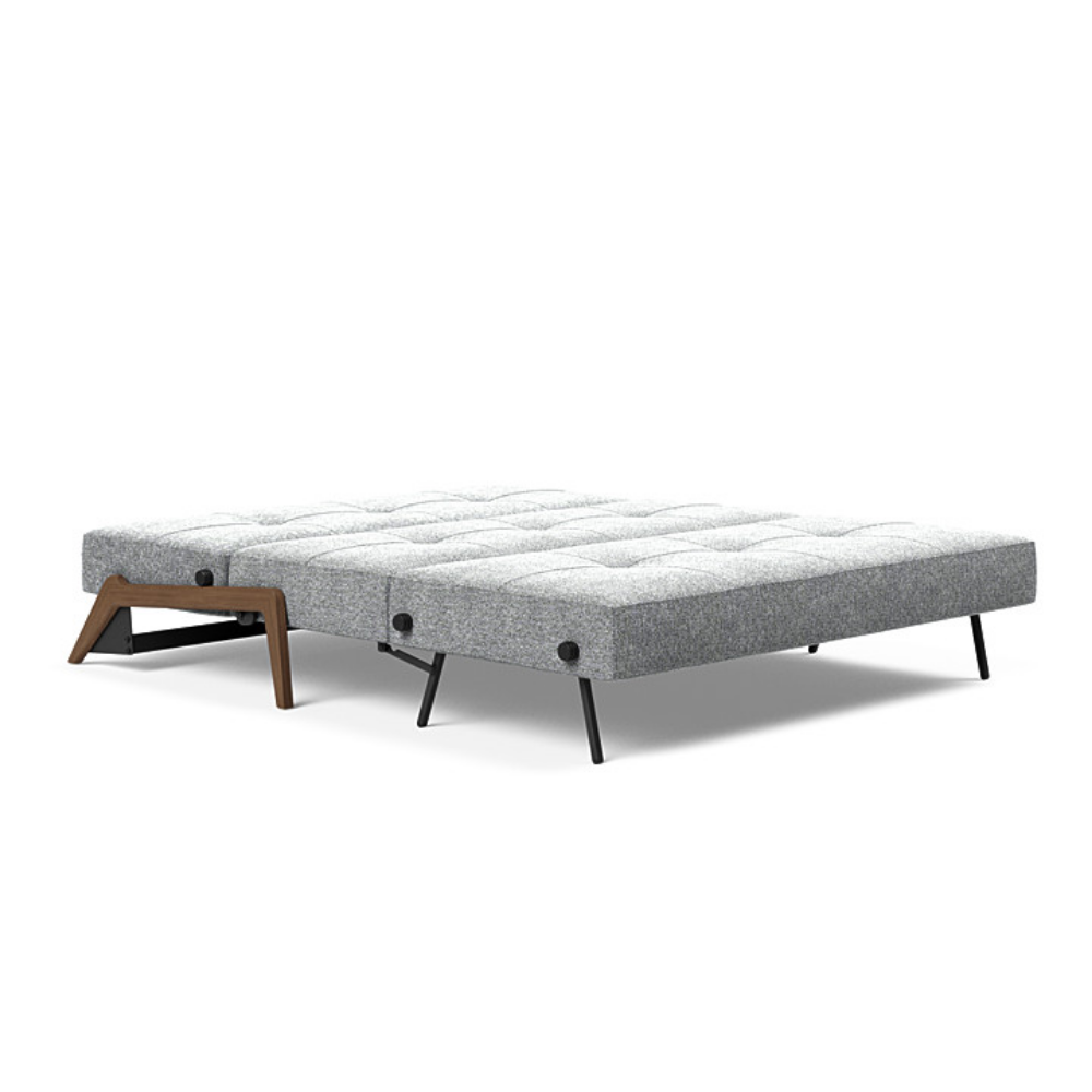 The Cubed Queen Size Sleeper Sofa with Wood Legs from Innovation Living with dark lacquered oak legs and taura slate grey 351 upholstery setup as a bed.