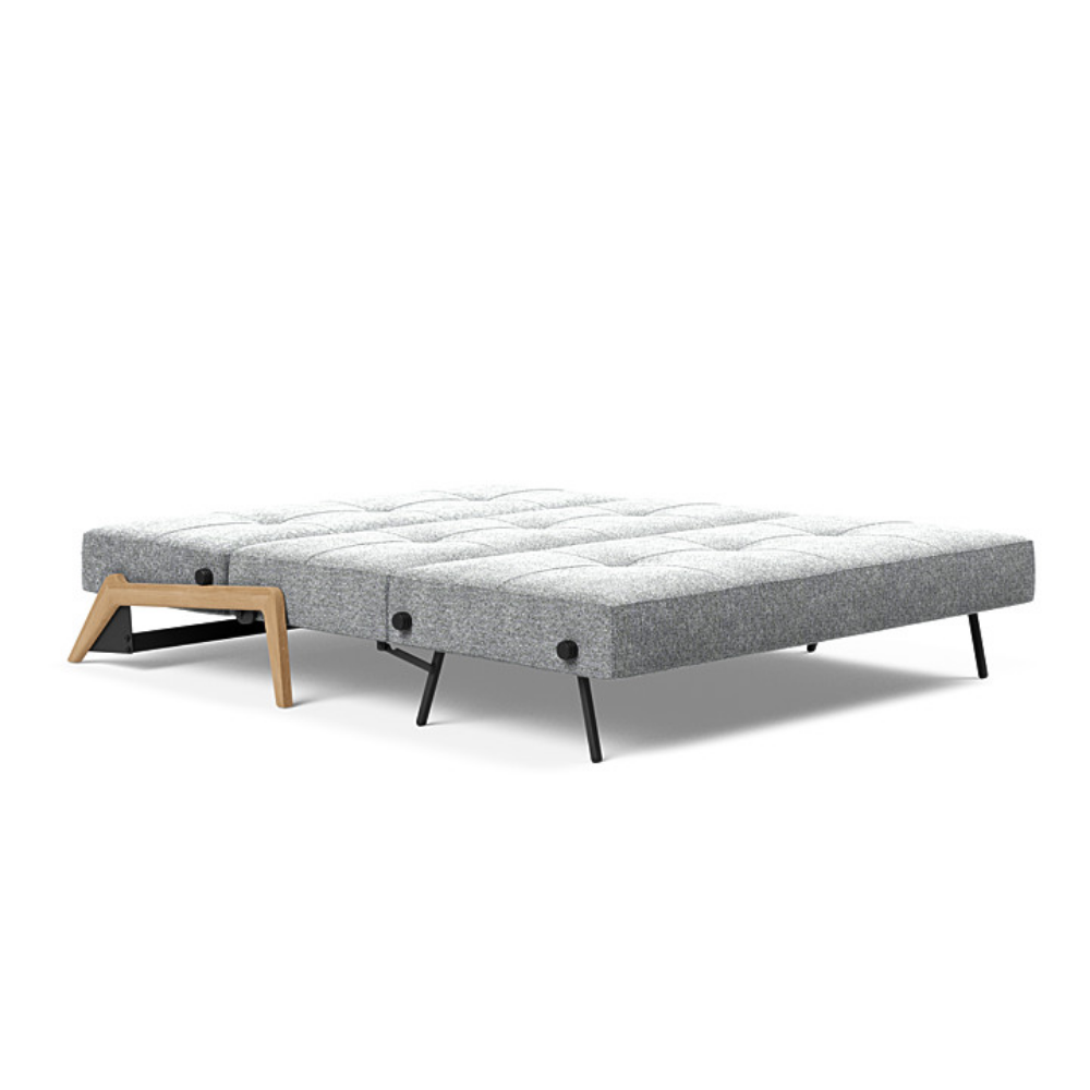 The Cubed Queen Size Sleeper Sofa with Wood Legs from Innovation Living with lacquered oak legs and taura slate grey 351 upholstery setup as a bed.