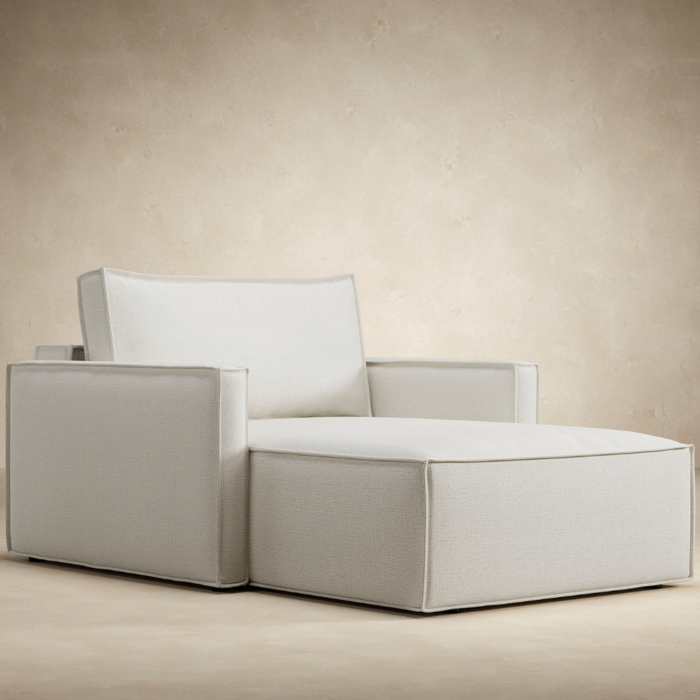 The Newilla Lounger Chair with Slim Arms from an angle in a living area. all-groups