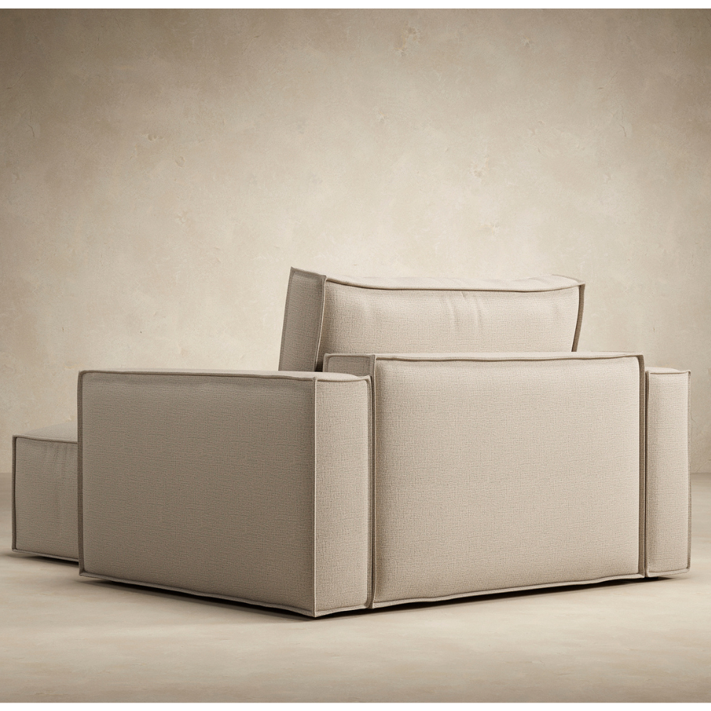 The Newilla Lounger Chair with Standard Arms from Innovation Living with adario taupe 257 upholstery from the back in a living area. all-groups