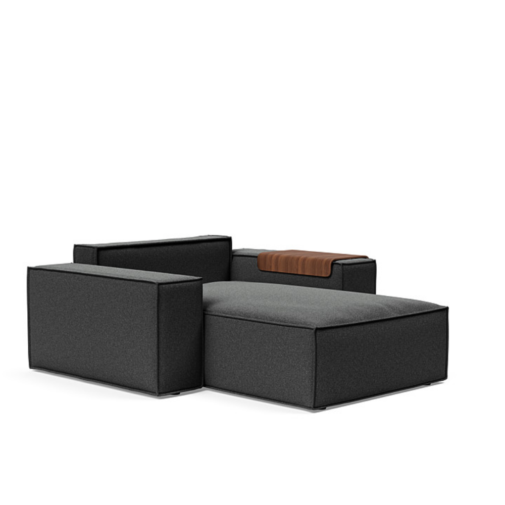 The Newilla Lounger Chair with Wide Arms from Innovation Living with boucle charcoal 529 upholstery without the cushion, setup as a bed.