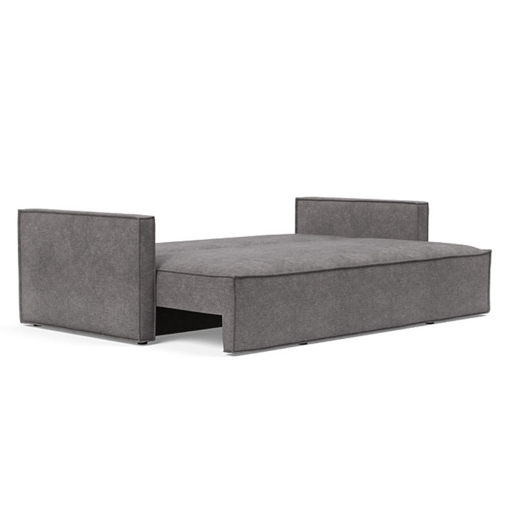 The Newilla Sleeper Sofa from Innovation Living with slim arms and avella warm grey 282 upholstery setup as a bed.