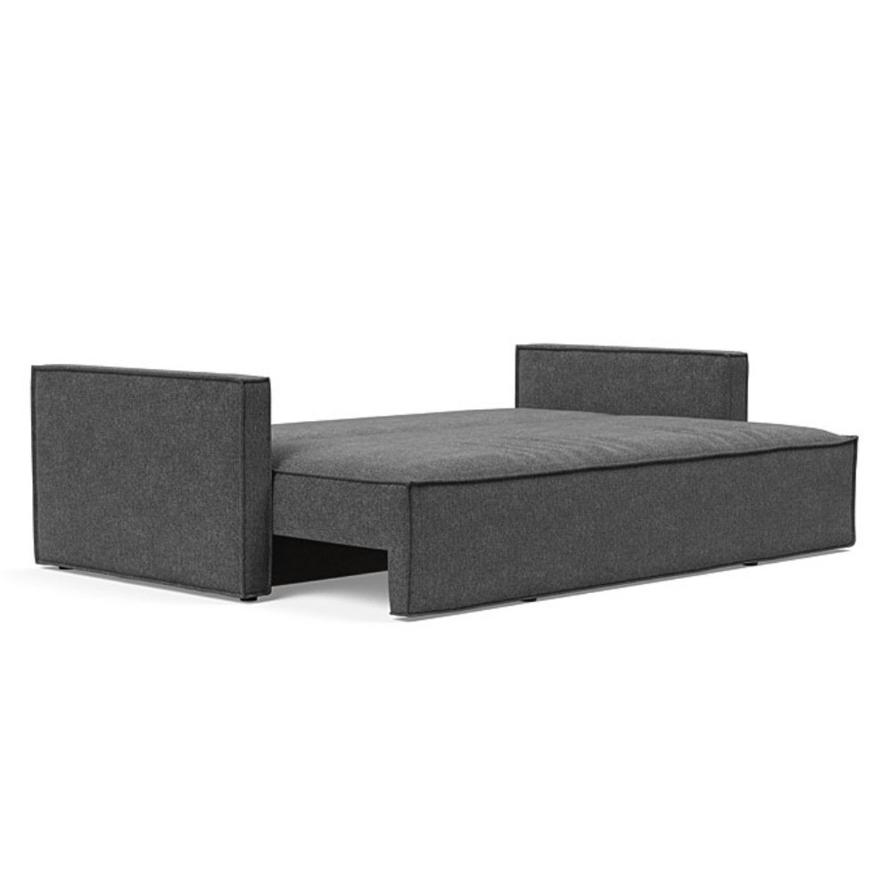 The Newilla Sleeper Sofa from Innovation Living with slim arms and taura deep grey 350 upholstery setup as a bed.