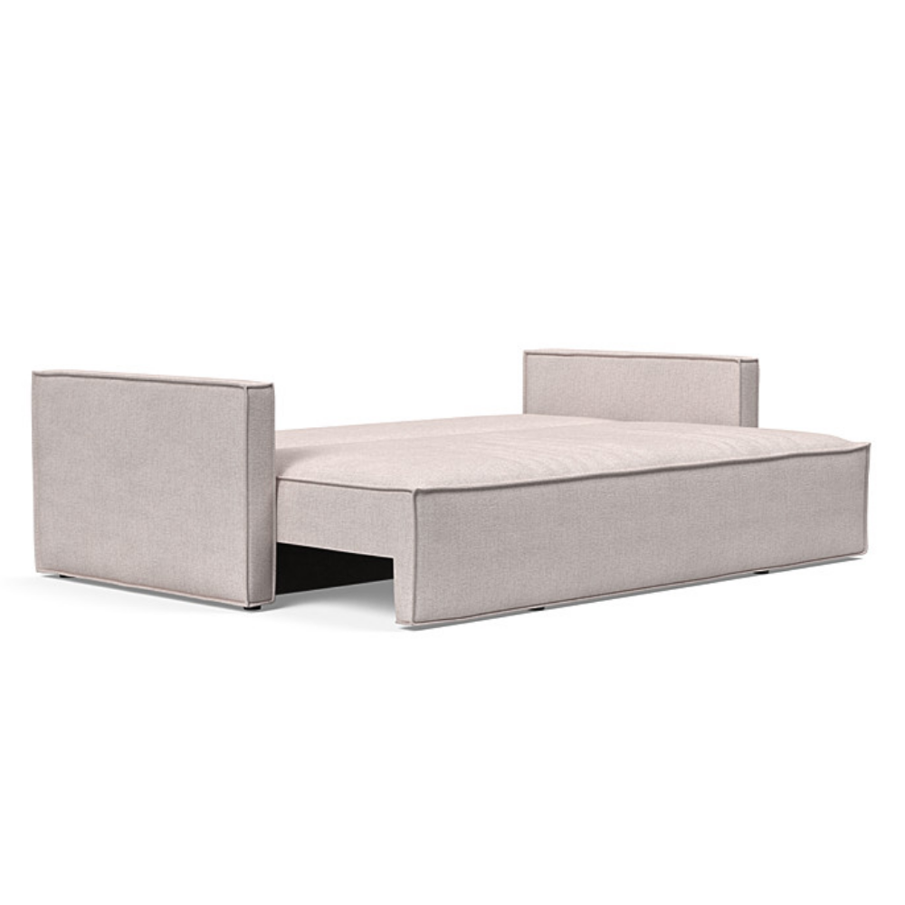 The Newilla Sleeper Sofa from Innovation Living with slim arms and weda sand 300 upholstery setup as a bed.