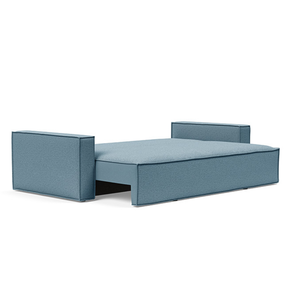The Newilla Sleeper Sofa from Innovation Living with standard arms and mixed dance light blue 525 upholstery setup as a bed.