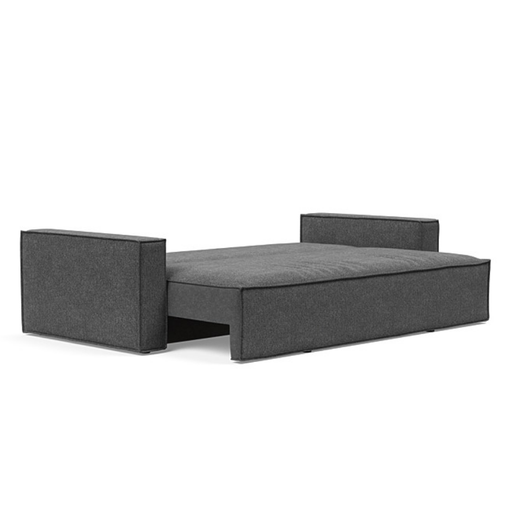 The Newilla Sleeper Sofa from Innovation Living with standard arms and taura deep grey 350 upholstery setup as a bed.