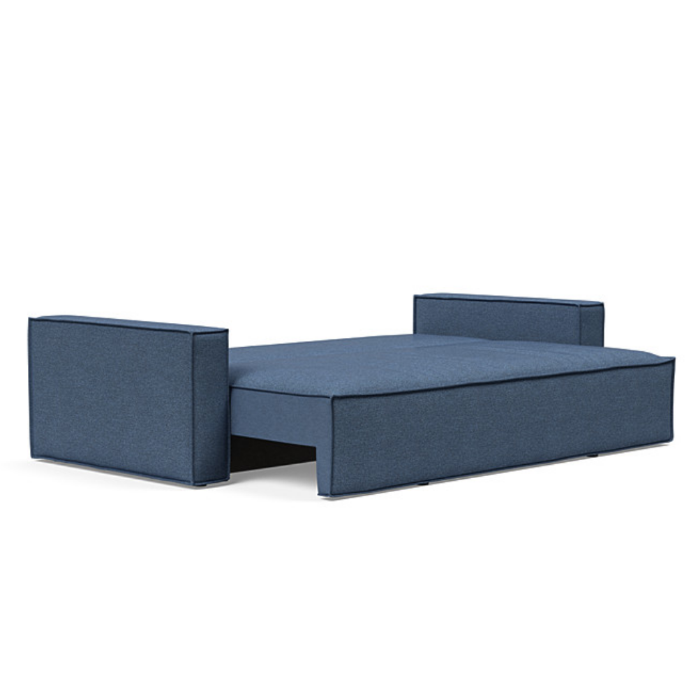 The Newilla Sleeper Sofa from Innovation Living with standard arms and weda blue 302 upholstery setup as a bed.