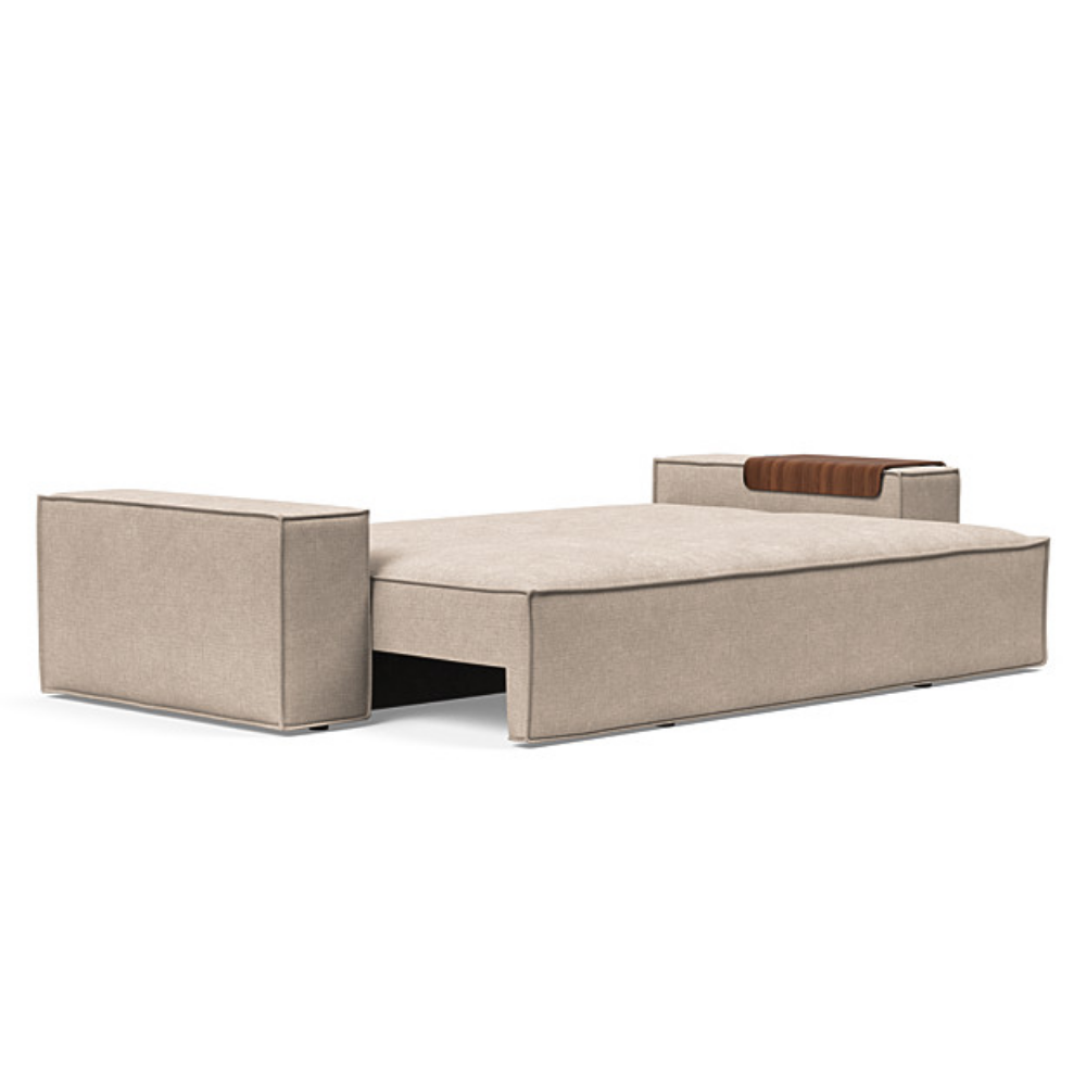 The Newilla Sleeper Sofa from Innovation Living with wide arms and adario taupe 257 upholstery setup as a bed.