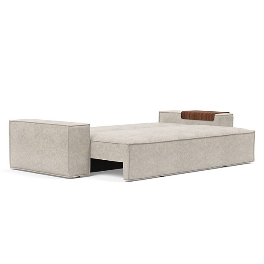The Newilla Sleeper Sofa from Innovation Living with wide arms and avella sand 280 upholstery setup as a bed.