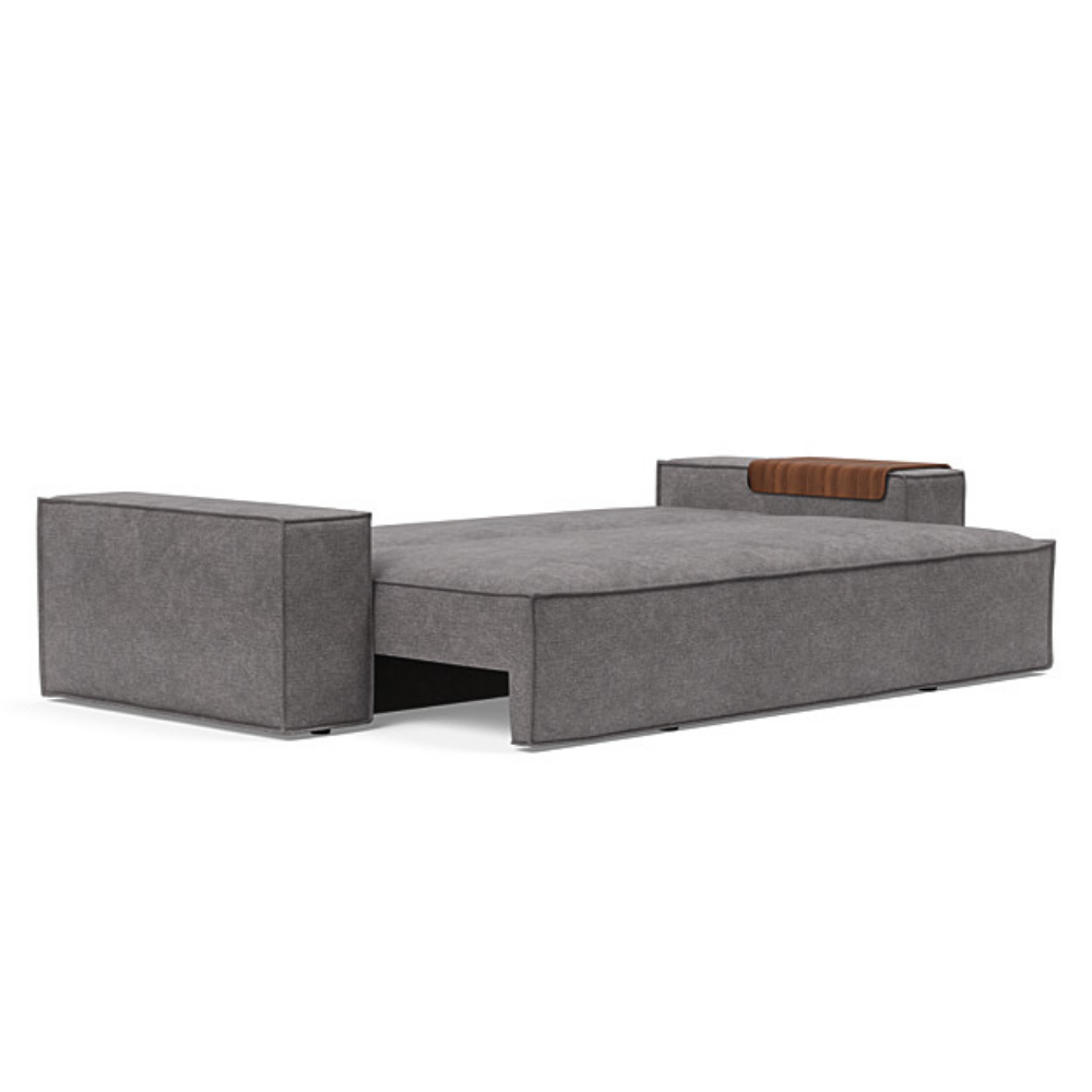 The Newilla Sleeper Sofa from Innovation Living with wide arms and avella warm grey 282 upholstery setup as a bed.