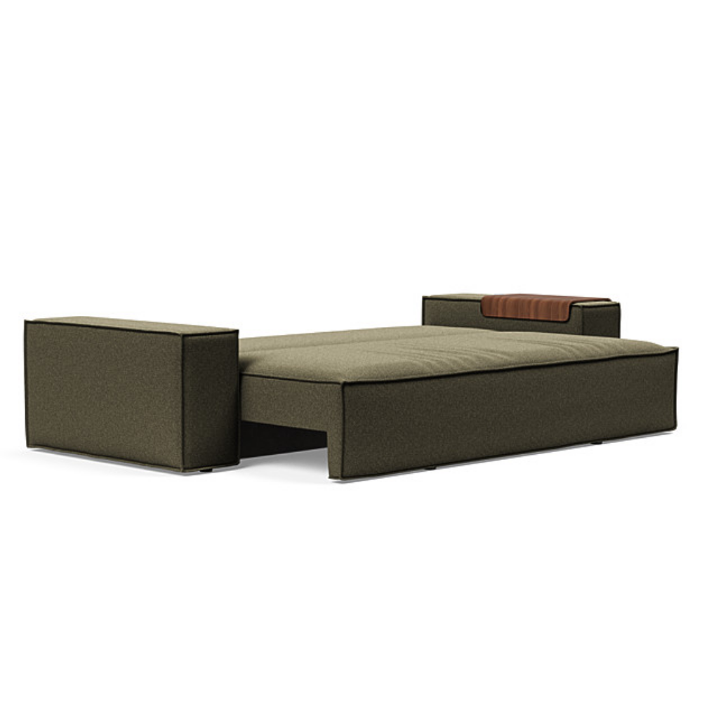 The Newilla Sleeper Sofa from Innovation Living with wide arms and boucle forest green 535 upholstery setup as a bed.