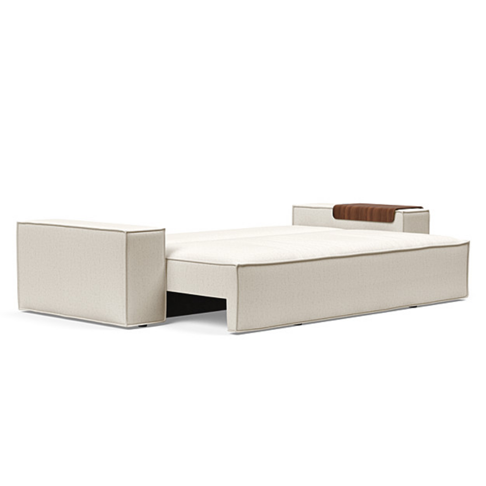 The Newilla Sleeper Sofa from Innovation Living with wide arms and boucle off white 531 upholstery setup as a bed.