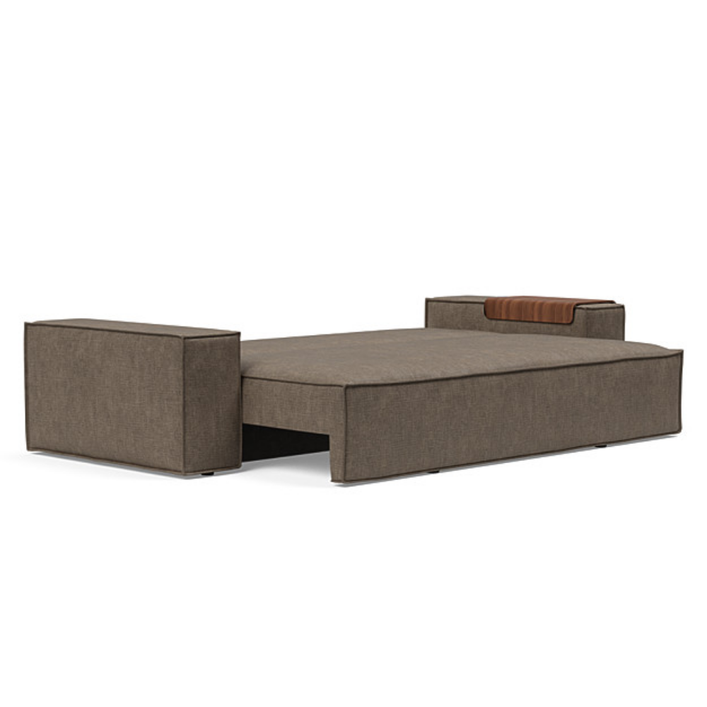 The Newilla Sleeper Sofa from Innovation Living with wide arms and esina cedar brown 411 upholstery setup as a bed.