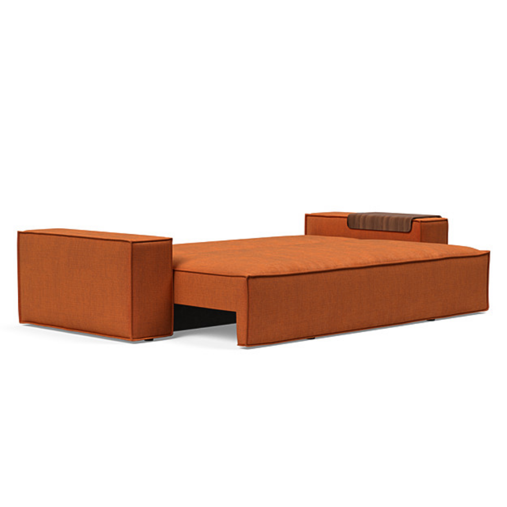 The Newilla Sleeper Sofa from Innovation Living with wide arms and esina rust orange 412 upholstery setup as a bed.