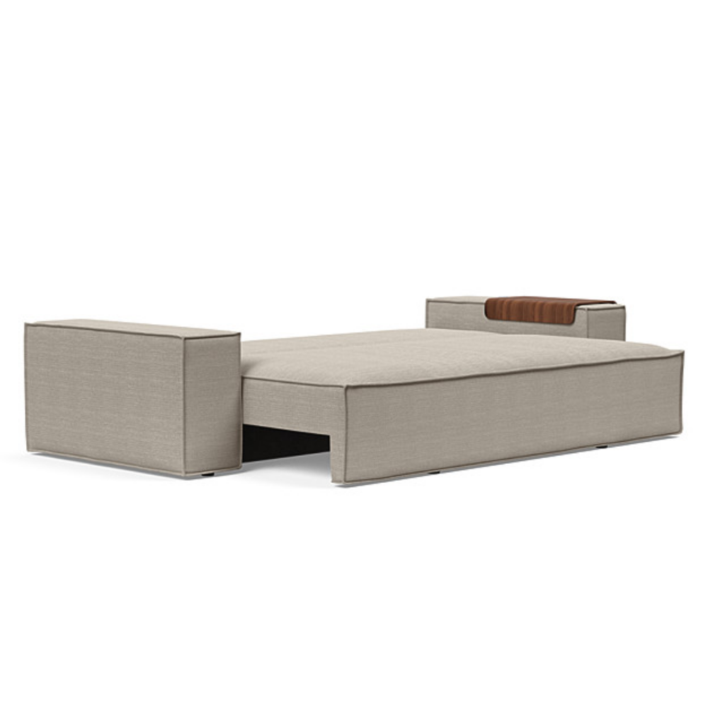 The Newilla Sleeper Sofa from Innovation Living with wide arms and kenya gravel 579 upholstery setup as a bed.