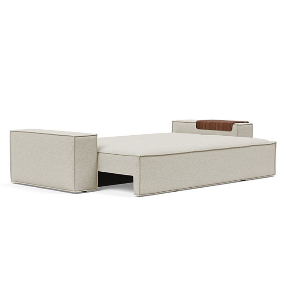 The Newilla Sleeper Sofa from Innovation Living with wide arms and mixed dance natural 527 upholstery setup as a bed.