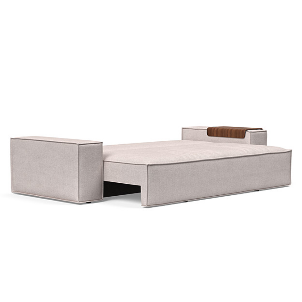 The Newilla Sleeper Sofa from Innovation Living with wide arms and weda sand 300 upholstery setup as a bed.