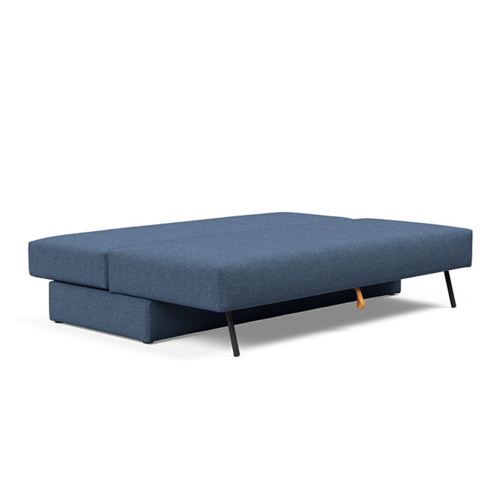 The Osvald Sofa Bed from Innovation Living with weda blue 302 upholstery setup as a bed.