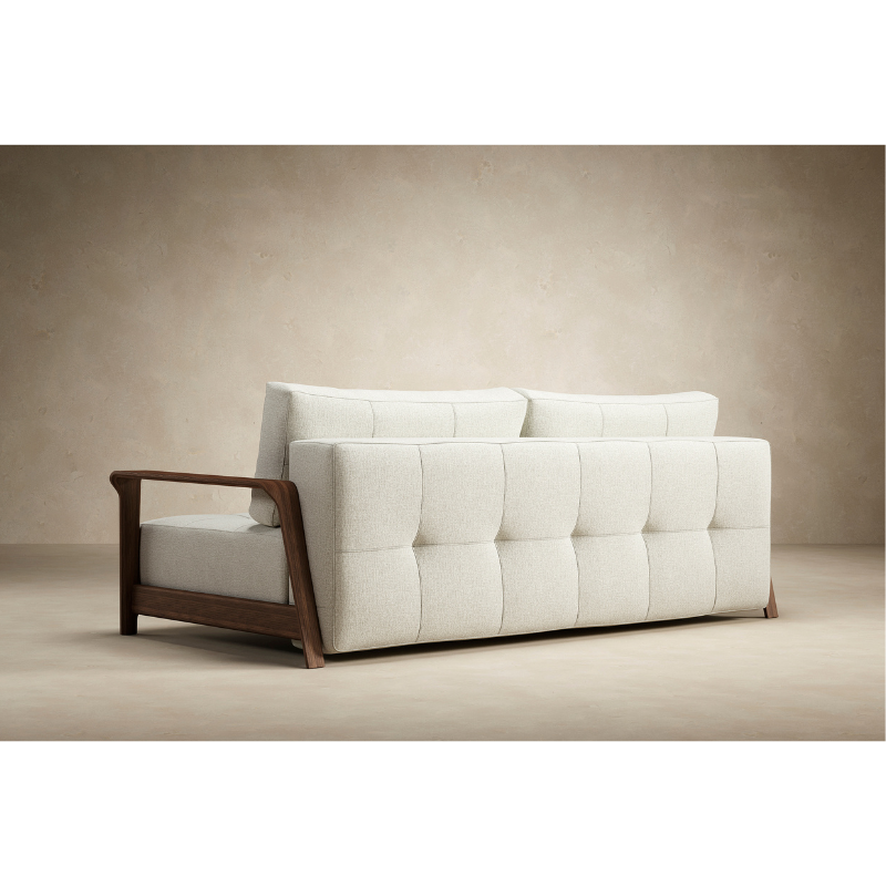 The Ran D.E.L Sofa Bed from Innovation Living with mixed dance natural 527 upholstery in a lounge.