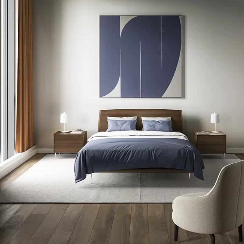 The Zile Table Lamp from Luceplan in matte white in a guest room.