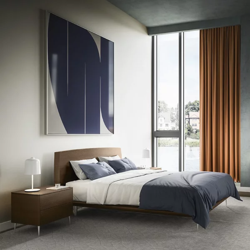 The Zile Table Lamp from Luceplan in matte white in a primary bedroom.