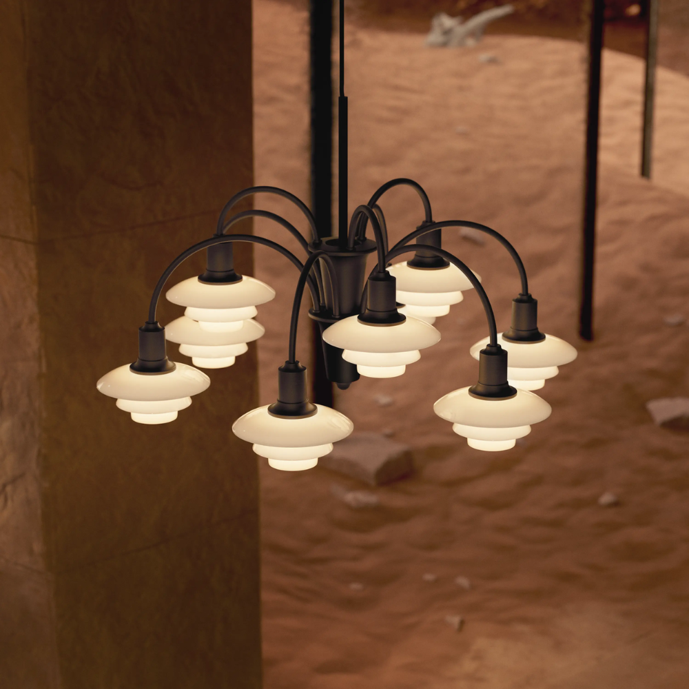Campaign photo of the PH 1/1 Chandelier, 9-Light by Louis Poulsen turned on.