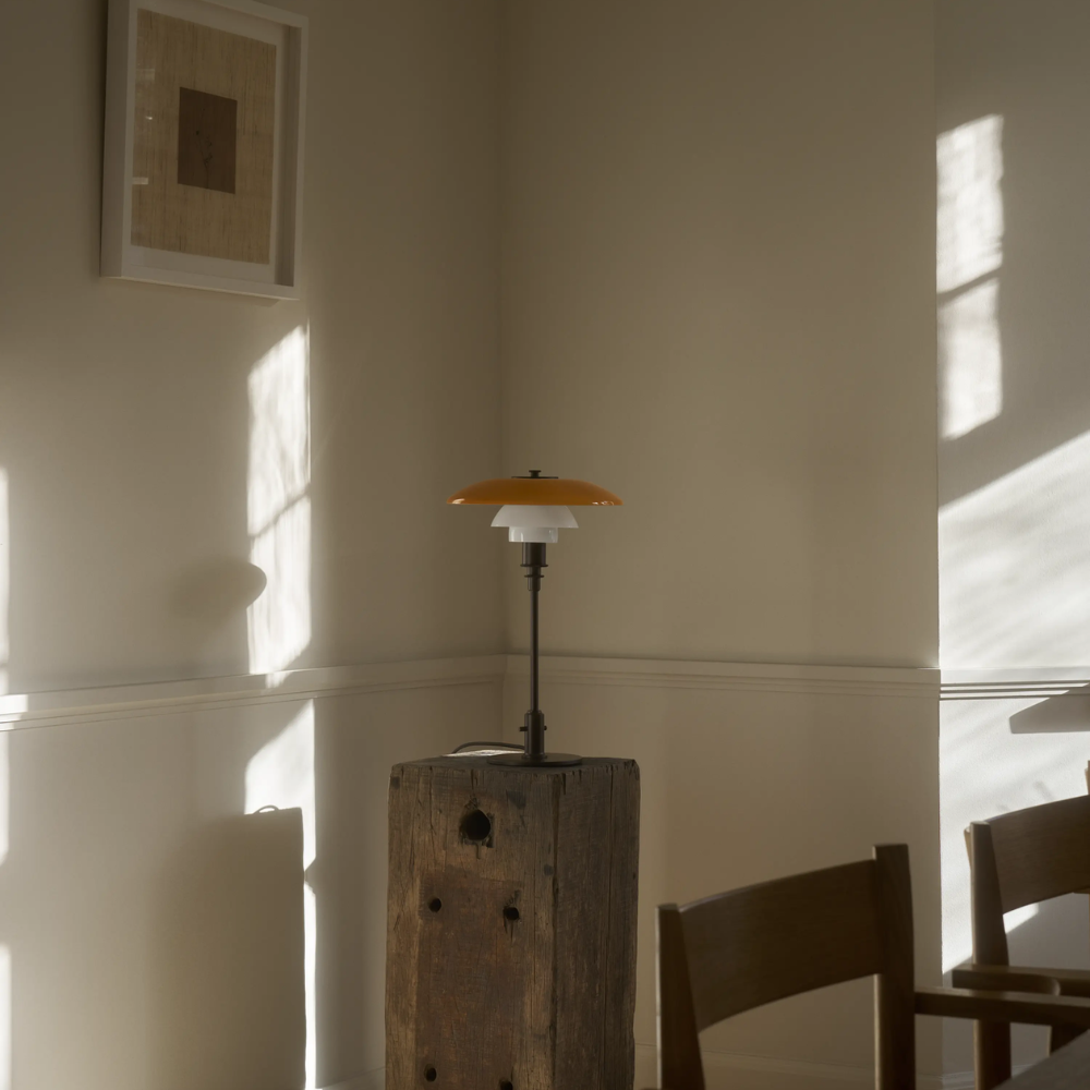 The PH 3/2 Table Lamp Centenary Edition by Louis Poulsen turned off in a dining room.