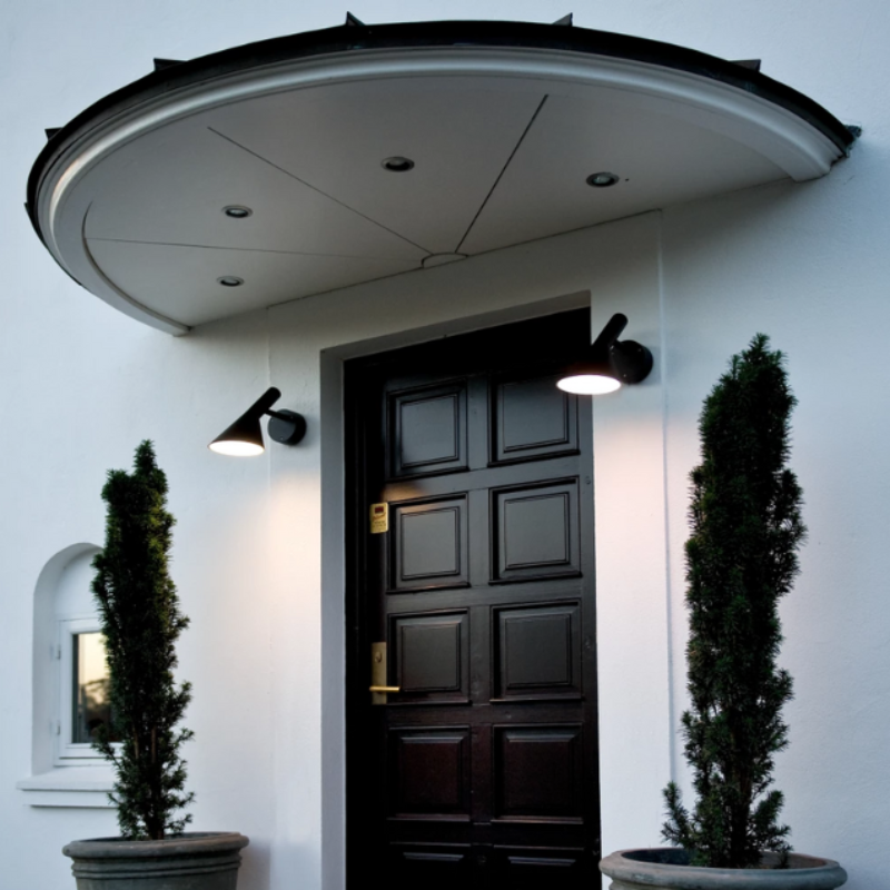 The AJ 50 Wall from Louis Poulsen in an outdoor doorway.